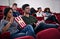 Catching the latest on the big screen. people enjoying watching a movie in a cinema.