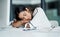 Catching a quick snooze. Shot of a young businesswoman sleeping at a desk in an office.