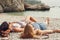 Catching some rays while we can. two unrecognisable women lying on the beach in Amalfi.