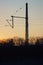 A catenary mast in the sunset
