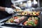 caterer organizing seared tuna steak dishes for an event