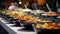 Catering buffet food on a long table in a hotel restaurant