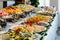 Catering buffet food on a long table in a hotel restaurant