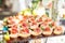 Catering buffet table with snacks and appetizers. Set of canapÃ©s with jamon, bruschetta and cheese