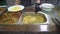 catering close-up of a waiter\'s hand in black rubber gloves behind a glass lays food rice in a white plate. protection