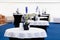 Catering, high buffet tables with a black and white tablecloth in lobby, large tent with blue floor. Concept banquet, table