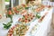 Catering. Off-site food. Buffet table with various canapes, sandwiches, hamburgers and snacks