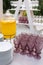 Catering, outdoor banquet in summer. Glasses, plates and keg with lemonade stand on a white wooden table at a banquet.