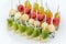 Catering for party. Close up of appetizers with watermelon, grapes, melon, kiwi, cheddar, parmesan, blue cheese over white plate