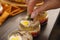 catering work. a sprig of dill is placed on jars with a salad of salted herring.