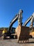 Caterpillar bulldozer stands near a quarry against a blue sky