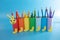 Caterpillar pencil holder, toilet paper roll craft concept, colorful tubes on blue background