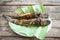 Catfish roasted on banana leaf - cooked catfish grilled Asian food on wooden table