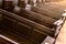 Cathedral benches. Rows of pews in christian church. Heavy solid uncomfortable wooden seats