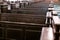 Cathedral benches. Rows of pews in christian church. Heavy solid uncomfortable wooden seats