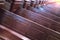 Cathedral benches. Rows of pews in christian church. Heavy solid uncomfortable wooden seats