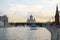 Cathedral of Christ the Savior, Moscow River with pleasure boats, bridge and tower of the Moscow Kremlin in the evening