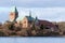 Cathedral or Dom of Ratzeburg seen from the Domsee lake in winter, an historic brick romanesque building in northern Germany, cop