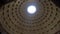 Cathedral interior and a round window in the ceiling of the dome and the sunlight shining through it. Stock. A historic