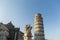 Cathedral, leaning tower and angels sculpture on Square of Miracles in Pisa,