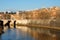 Cathedral over bridge and river water at fall day Rome, Italy