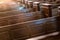 Cathedral pews. Rows of benches in christian church. Heavy solid uncomfortable wooden seats