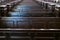 Cathedral pews. Rows of benches in christian church. Heavy solid uncomfortable wooden seats