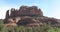 Cathedral Rocks rises over an amber field in Sedona