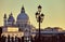 Cathedral of Santa Maria della salute street lamp on embankment in Venice sunset Italy.