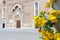 Cathedral Santa Maria Maggiore of Udine, Italy, with yellow flowers