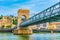 Cathedral in Vienne viewed behind a pedestrian bridge over river Rhone, France