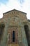 Cathedral wall with a window and stone carvings