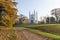 Catholic chapel among autumn nature, path with fallen leaves, tr
