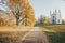 Catholic chapel in the Park in the autumn,  trees with Golden leaves, path is covered with fallen leaves