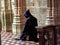 Catholic Christian Monk kneeling in humble prayer asking God for help