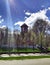 The Catholic Church, the blue sky, behind the green trees, in the sun