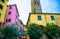 Catholic Church of San Giovanni Battista chiesa with clock tower, colorful buildings houses and flowers around in Monterosso villa