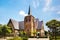Catholic Church Sint-Martinuskerk in Houthalen-Helchteren, Belgium. Man on a bicycle