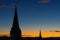 Catholic church towers on a wonderful orange blue evening sky background