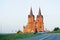 Catholic church with two towers at road in Poland