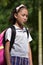 Catholic Diverse Female Student Winking Wearing Uniform With Books