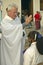 Catholic Priest blesses a woman in San Lazaro Catholic Church in El Rincon, Cuba