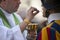 Catholic priest giving a Swiss Guard the Holy Communion