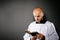 Catholic priest in white surplice reading bible