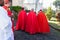 Catholic priests walk towards an open-air Palm Sunday mass