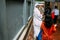 Catholic Sister is talking with children in front of House of Mother Teresa in Kolkata, India