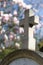 Catholic stone cross with beautiful springtime magnolia flowers, blurred background