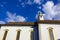 catholich church with blue yellow facade on blue sky