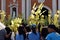 Catholics waving coconut palm leaves in celebrating Palm Sunday before Easter, Church tower background, The feast commemorates Jes
