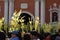 Catholics waving coconut palm leaves in celebrating Palm Sunday before Easter, Church tower background, The feast commemorates Jes